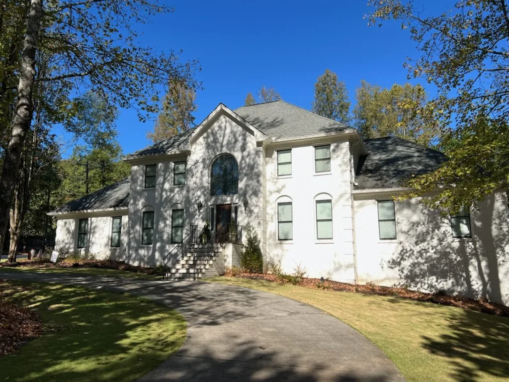 Daytime exterior view of a large two-story residential home for seasonal lighting planning.