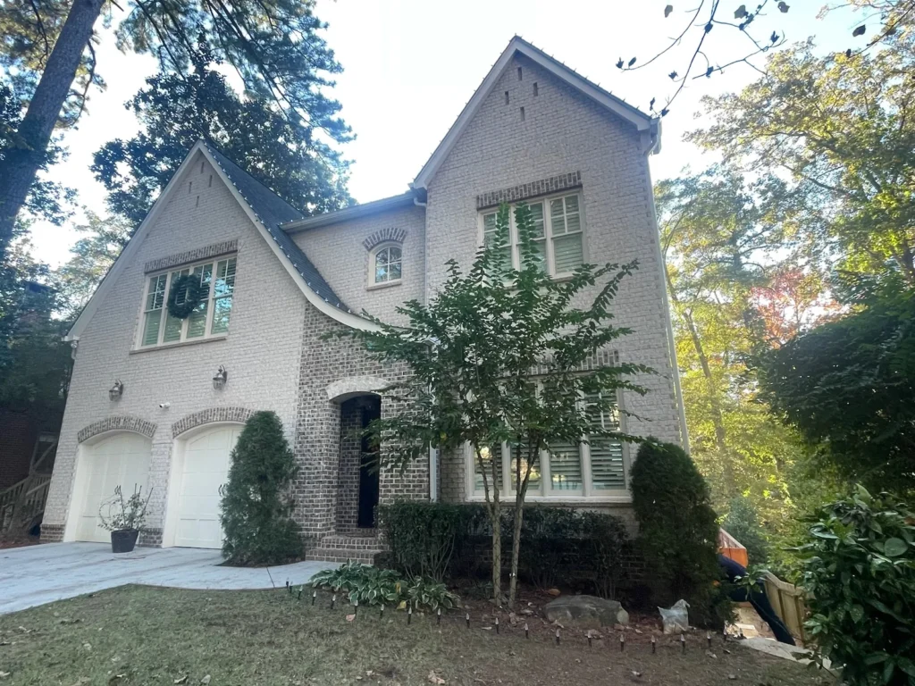 Daytime exterior of a white residential home for custom holiday lighting design and installation planning.